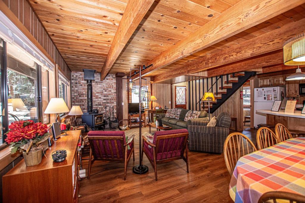 a living room with a table and chairs in a room at Das Berghaus By Hauserman Rentals in Tahoe City