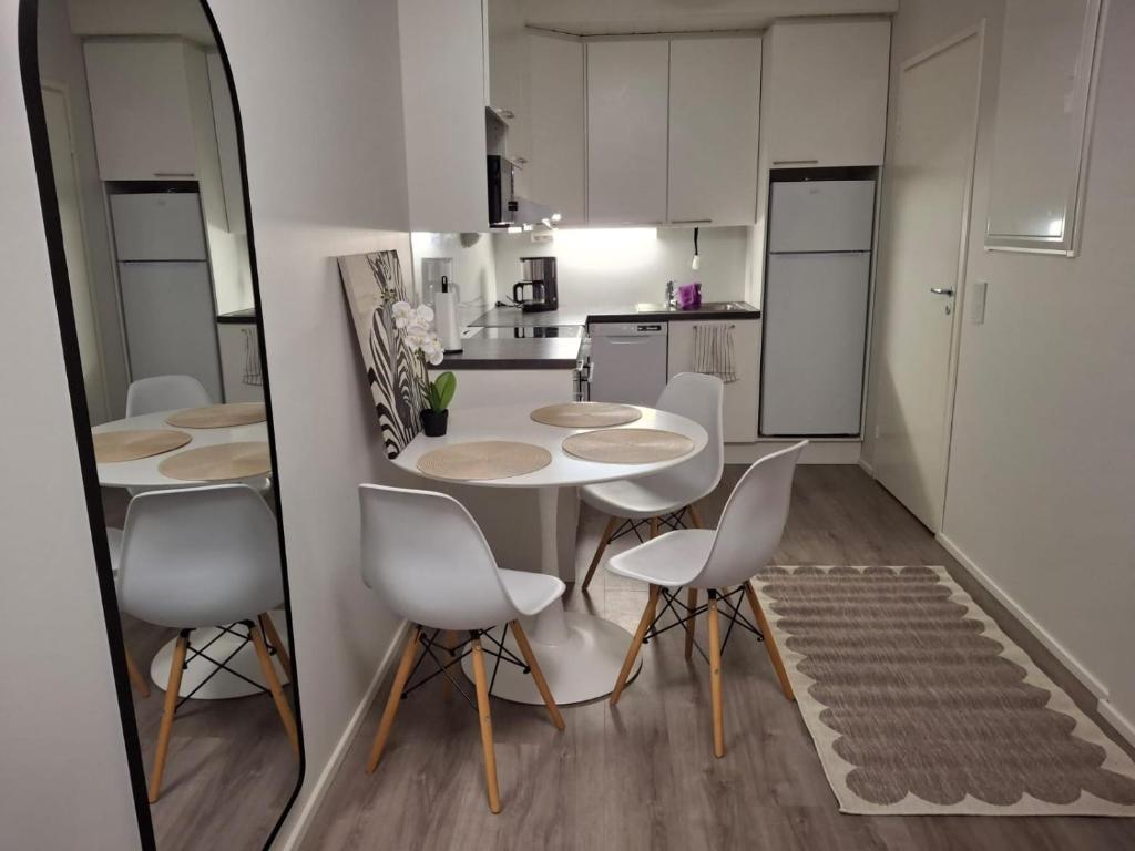 a room with a table and chairs in a kitchen at Easy Stay Mikkeli in Mikkeli