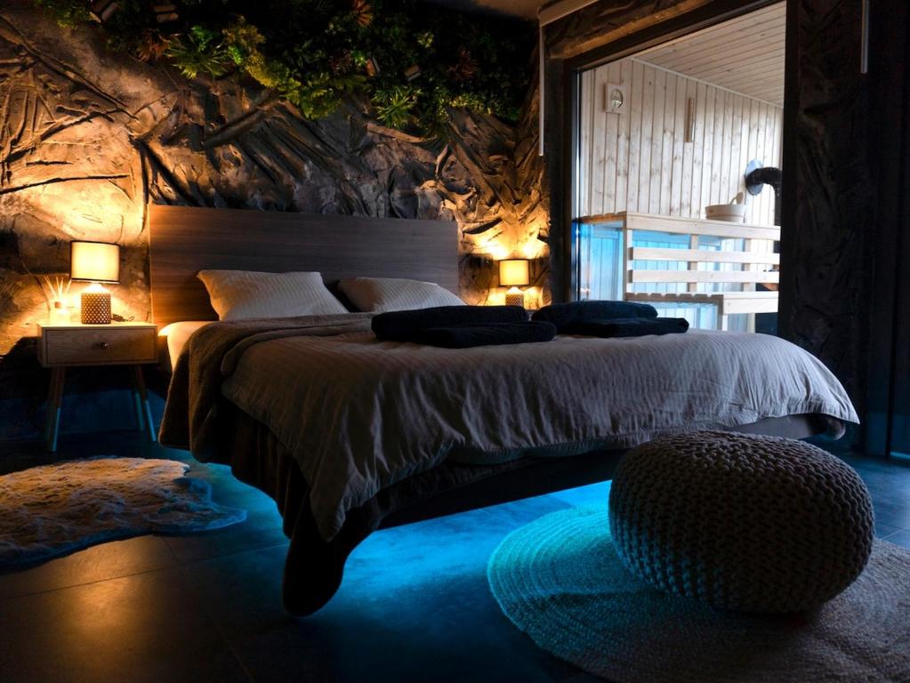 a bedroom with a large bed and a large window at Forest Whisper by GoldenPinpoint in Leštakovec