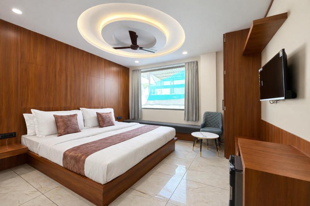 a bedroom with a bed and a ceiling fan at Planet Eco Stays - Near Mahakal Temple in Ujjain