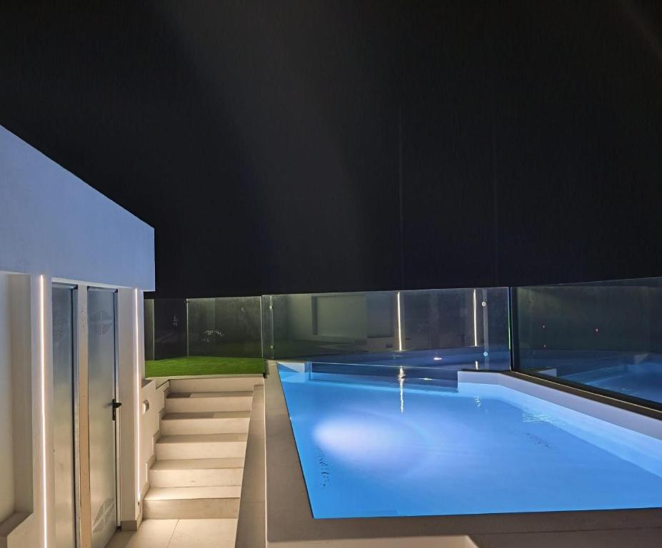 a swimming pool in a house with a black ceiling at Apartamentos Arinaga Ocean View in Arinaga