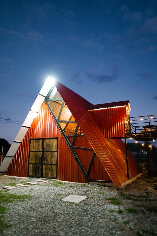 a red building with a light on top of it at Casa Monte Bello- Cabaña privada in Huehuetenango