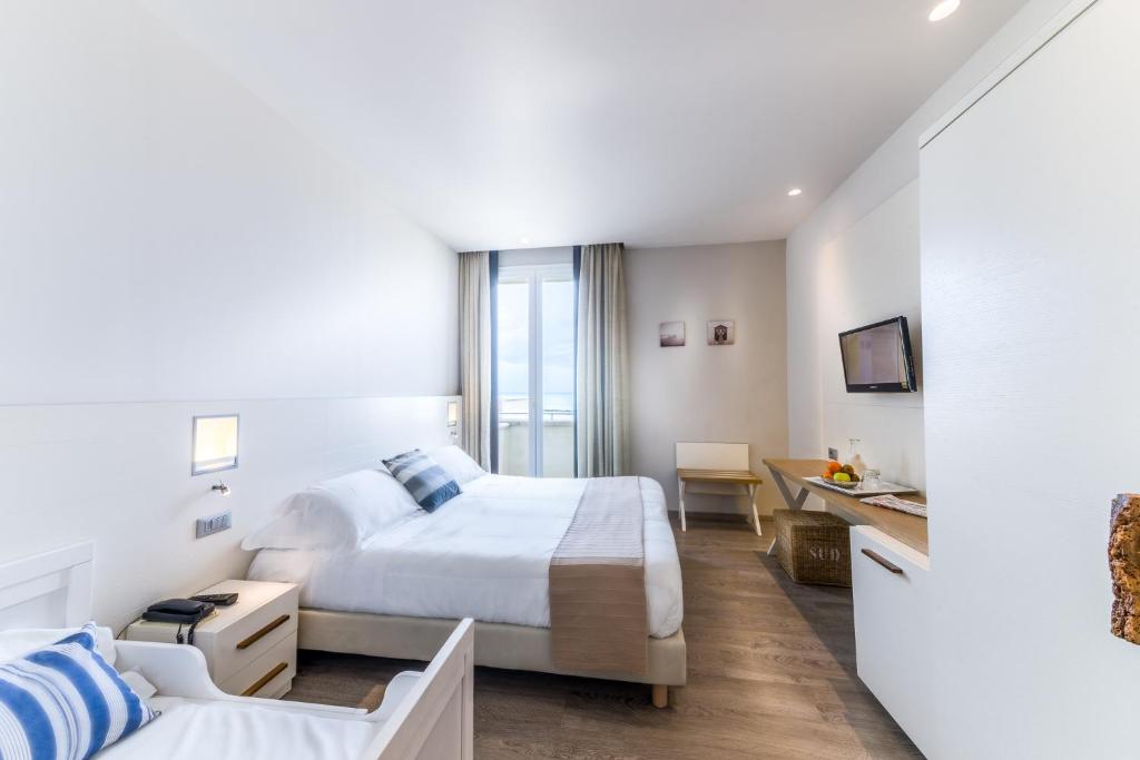 Postel nebo postele na pokoji v ubytování Hotel Agostini