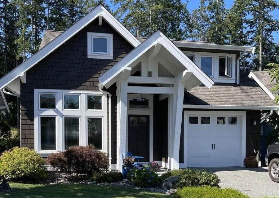 a house with a white garage at Qualicum Landing Paradise in Qualicum Beach