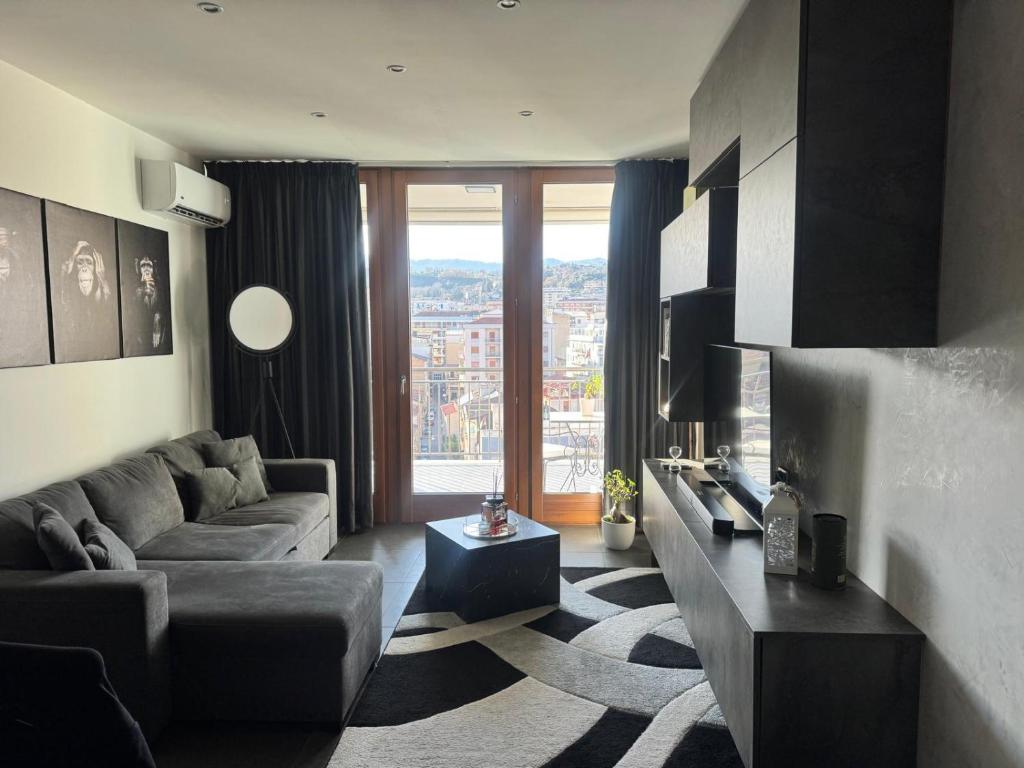 a living room with a couch and a large window at Full casa 1 in Cosenza
