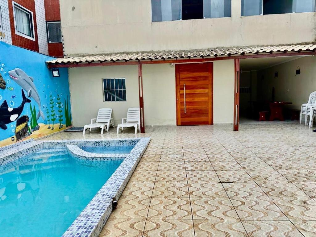 a house with a swimming pool next to a building at Casa grande in Garanhuns