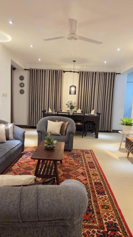 a living room with two couches and a piano at Casa Jose - 2BR with King Beds, Near Airport and Beach, 5G Wi-Fi in Wattala