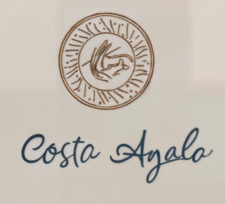 a picture of a coin with the words otica arabi at Costa Ayala - Suites & Bungalows in Los Ayala