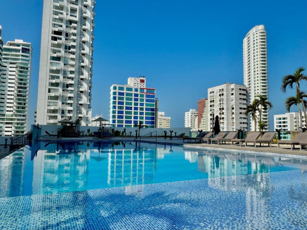 a large swimming pool in a city with tall buildings at Apartamento Special For You in Cartagena de Indias