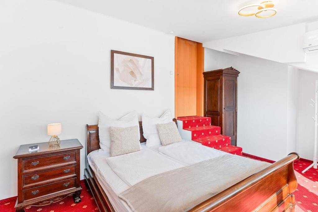 a bedroom with a bed and a dresser and a chair at Scharnhäusle 15 - Guest room Ostfildern in Ostfildern