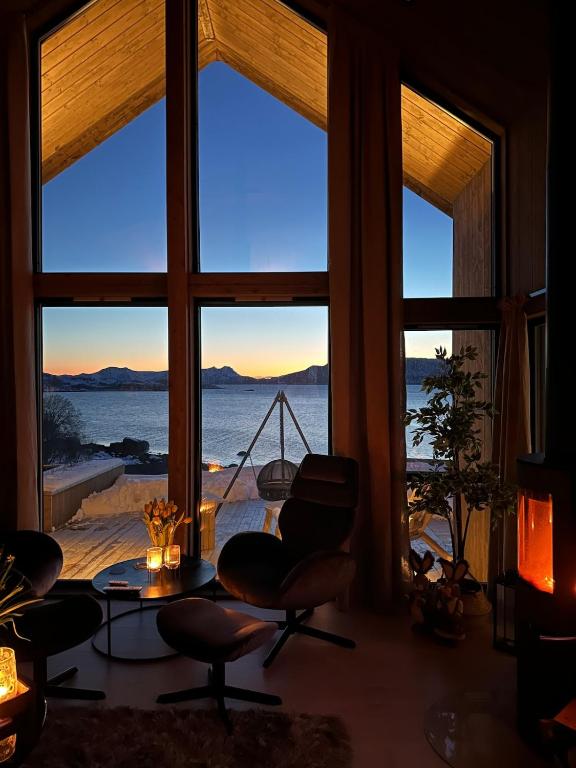 a room with a large window with a view of the ocean at Cabin with sea view in Moen