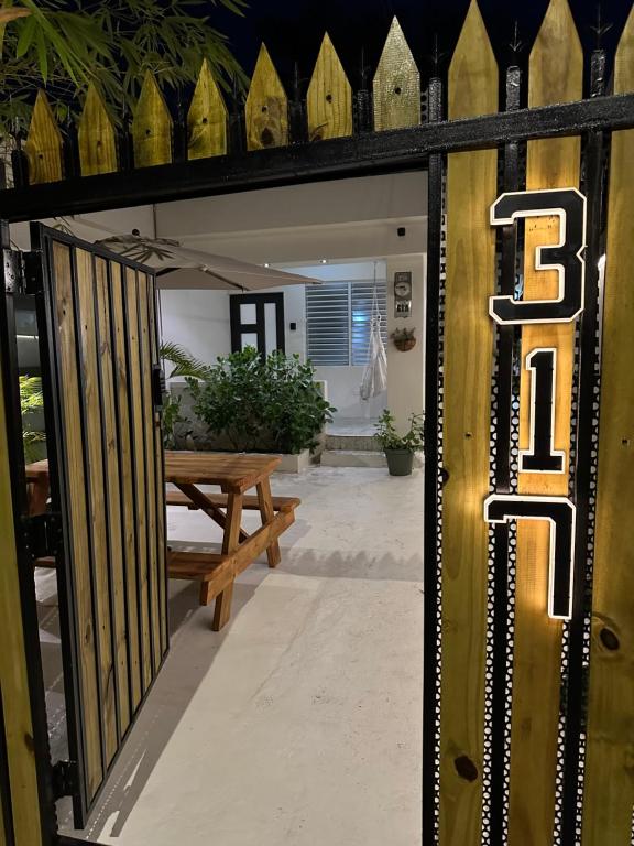 an open door to a patio with a bench at Villa Bamboo in San Juan