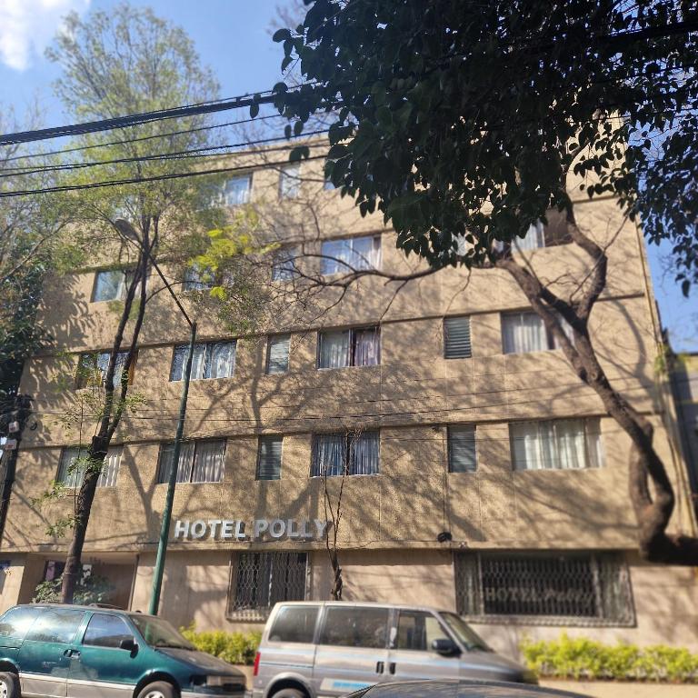 two cars parked in front of a building at Hotel polly in Mexico City