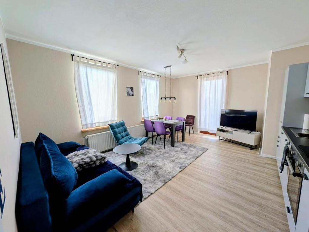 a living room with a couch and a table at Jessis Harz Appartements in Sankt Andreasberg