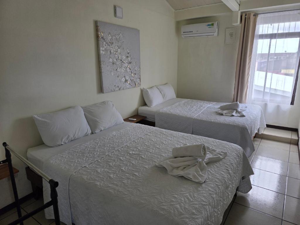 a hotel room with two beds with towels on them at Fortuna garden hotel in Fortuna