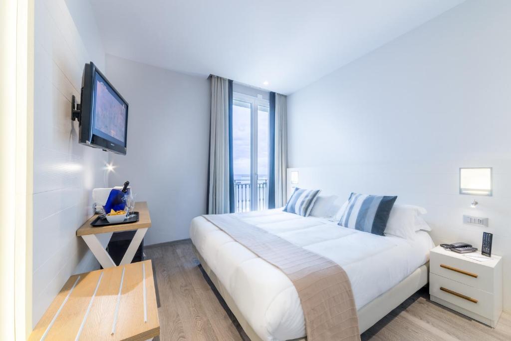 Postel nebo postele na pokoji v ubytování Hotel Agostini