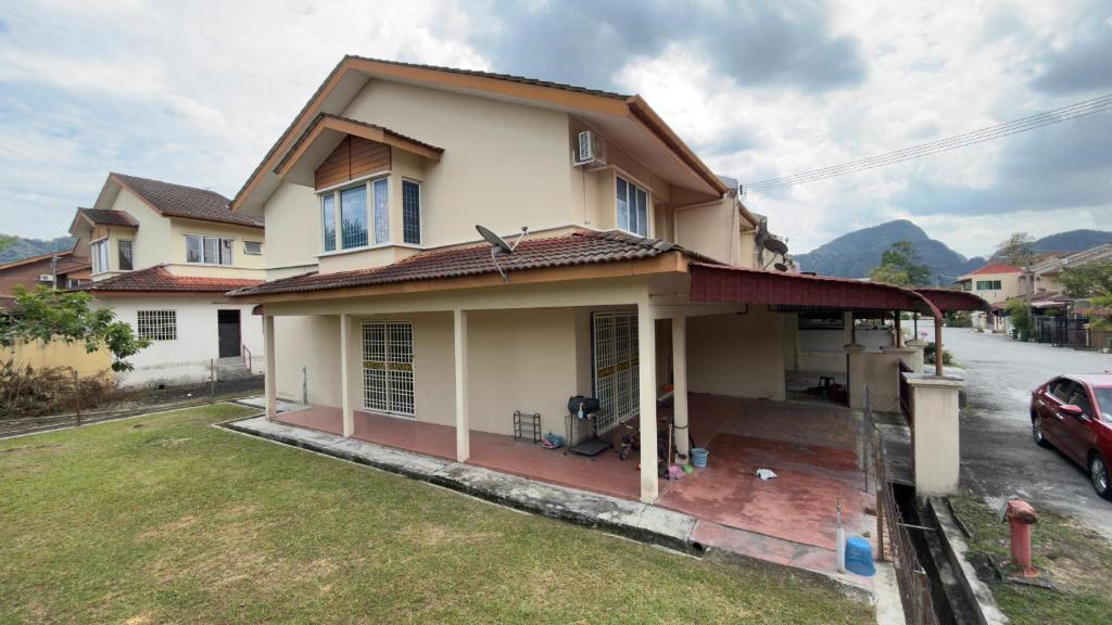 a house with a car parked in front of it at De'Bestari Homestay in Ipoh