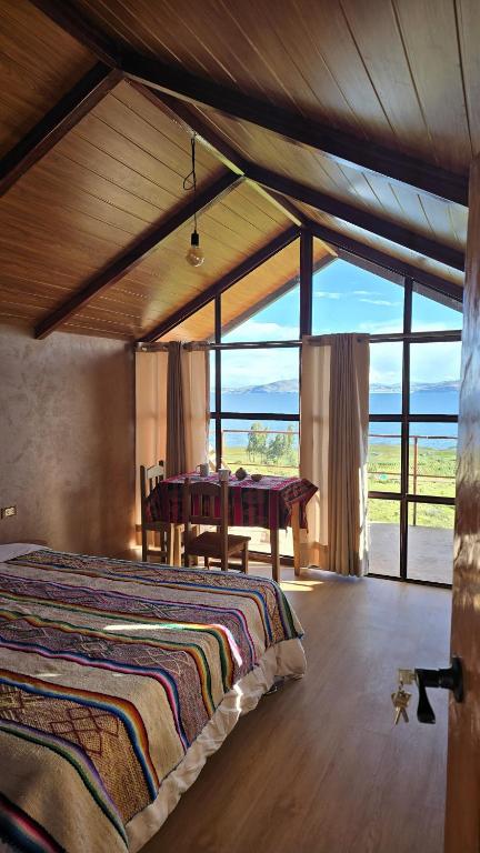 a bedroom with a bed and a table in it at Casa de Primo in Puno