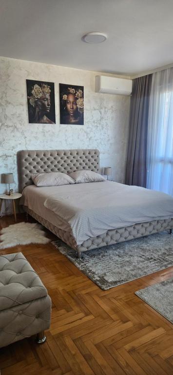 a bedroom with a large bed in a room at Apartman Tajna in Sremčica