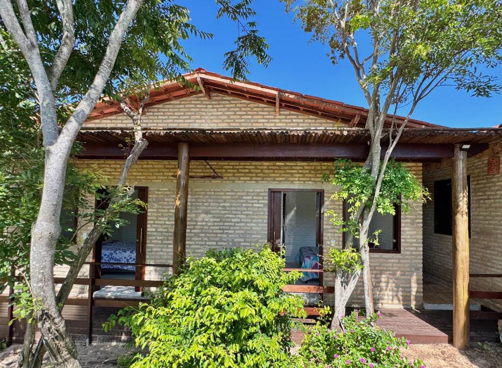 a small brick house with a porch at Mango Village Paracuru CE in Paracuru