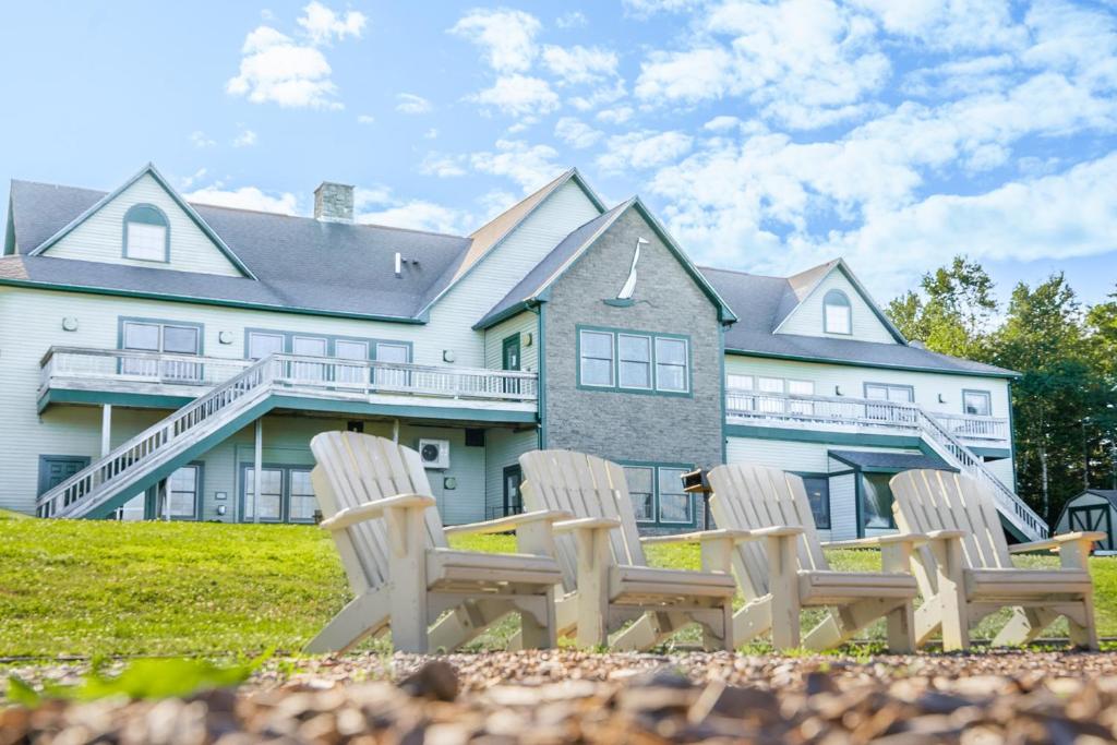 a group of chairs in front of a house at Harbor Ridge in Southwest Harbor