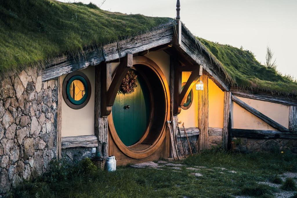 a house with a grass roof with a green door at La Comarca de Vératton in Villanueva de la Vera