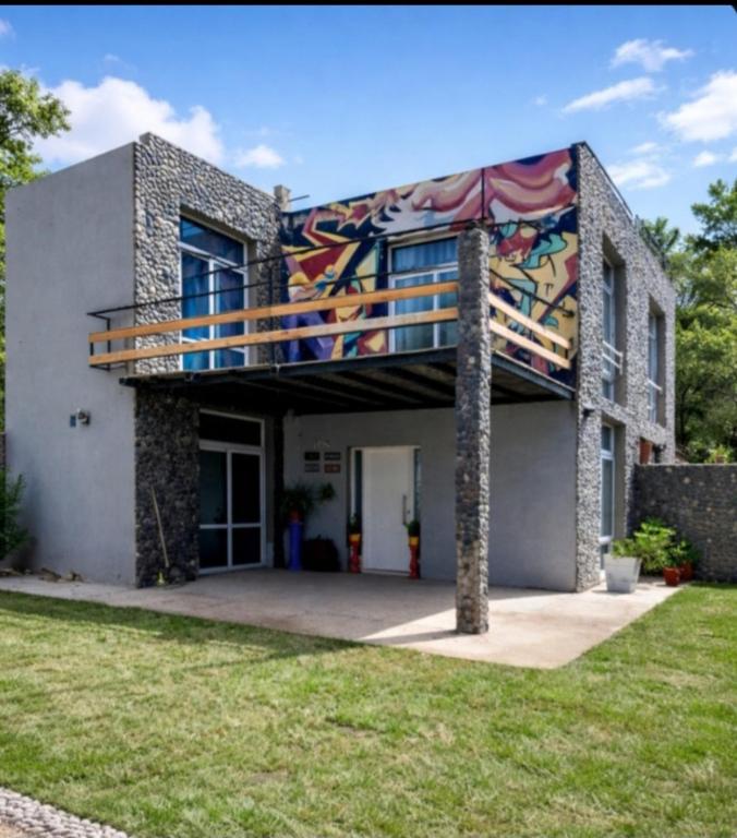 a house with a mural on the side of it at El Pedregullo in Neuquén