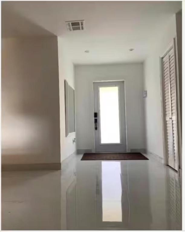 a white room with a door and a window at Bedroom with Bathroom 1 in Boca Raton