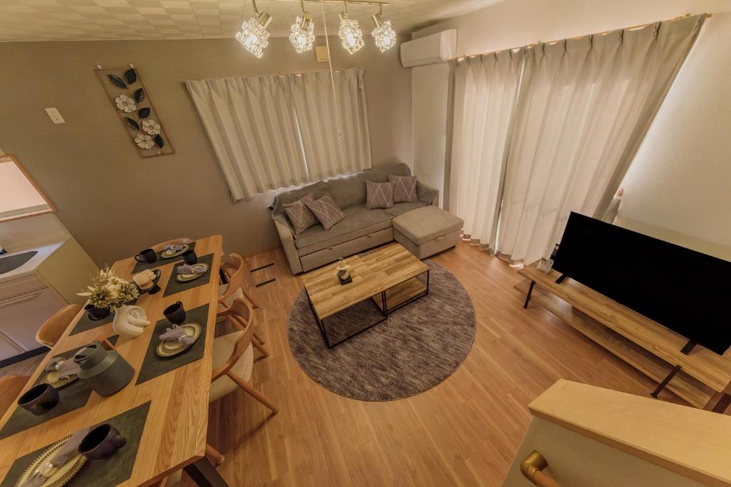 a living room with a couch and a table at ベル高崎 in Takasaki