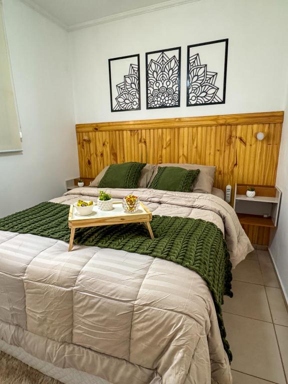 a bedroom with a large bed with a table on it at Apê 302 prox ao SESC in Franca