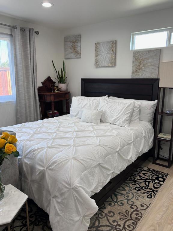 a bedroom with a large bed with white sheets at Yellow Gate Executive Retreat in San Jose