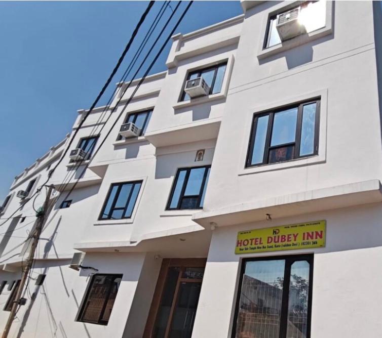 a white building with a sign in front of it at Hotel Dubeyinn in Katra