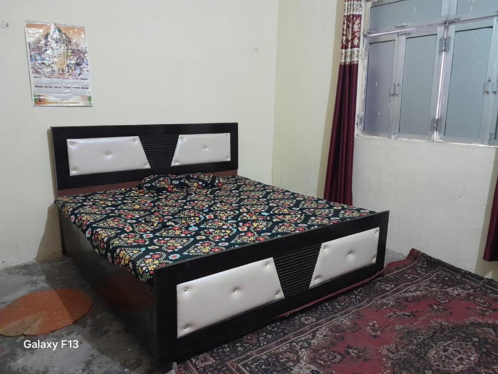 a bedroom with a bed in a room with a window at ram sadan in Ayodhya