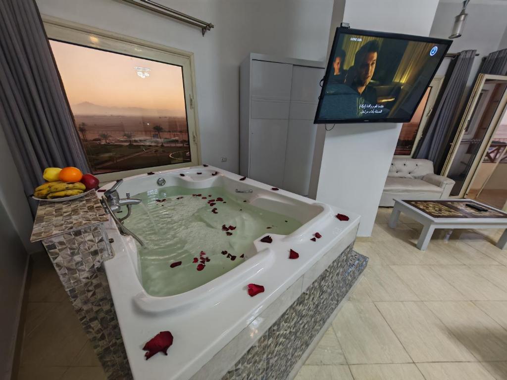 a bath tub with a tv in a room at Avrio Red Sea in Hurghada