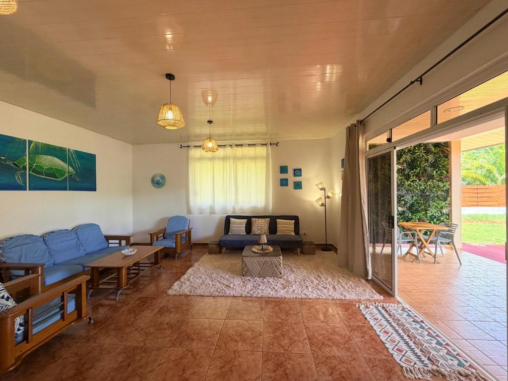 a living room with a couch and a table at Fare Hinenao in Tevaitoa