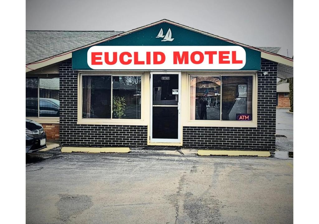 a brick building with a sign that reads quick motel at Euclid Motel in Bay City