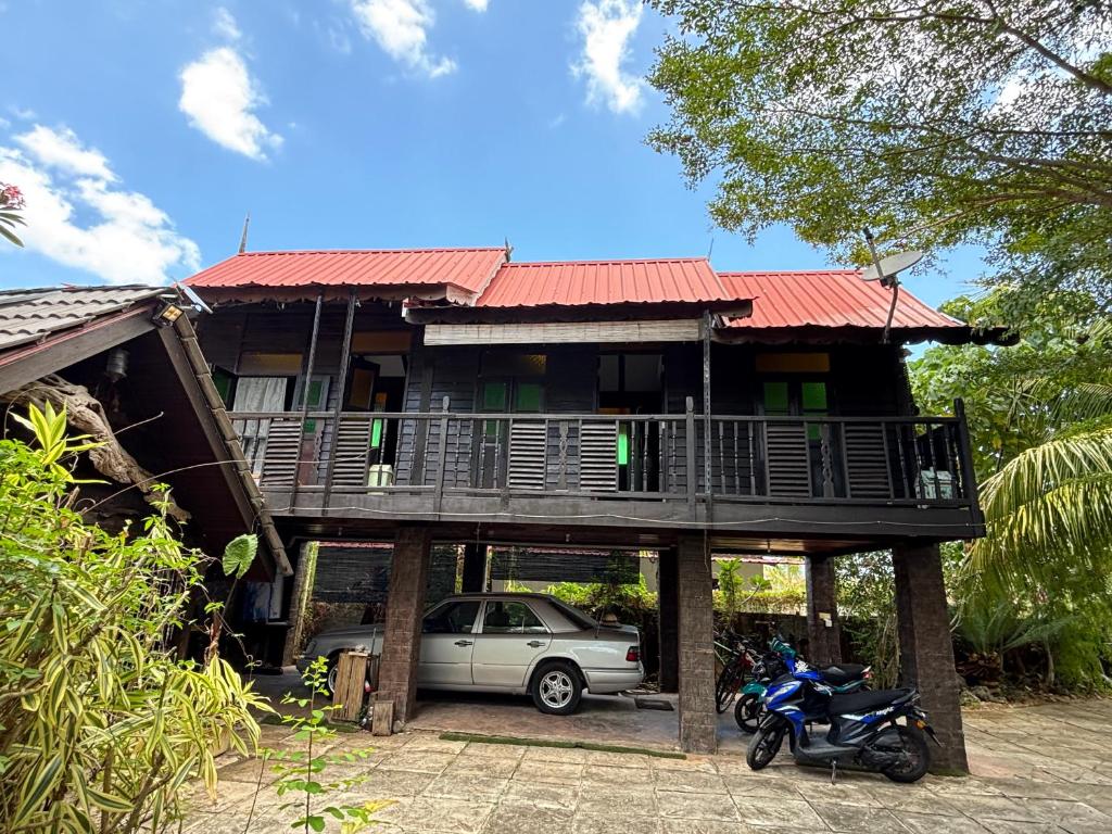a house with a car parked in front of it at Gio Private Villa - Langkawi in Langkawi Intl