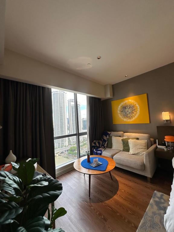 a living room with a couch and a table at Hotel Residence at Novotel in Manila