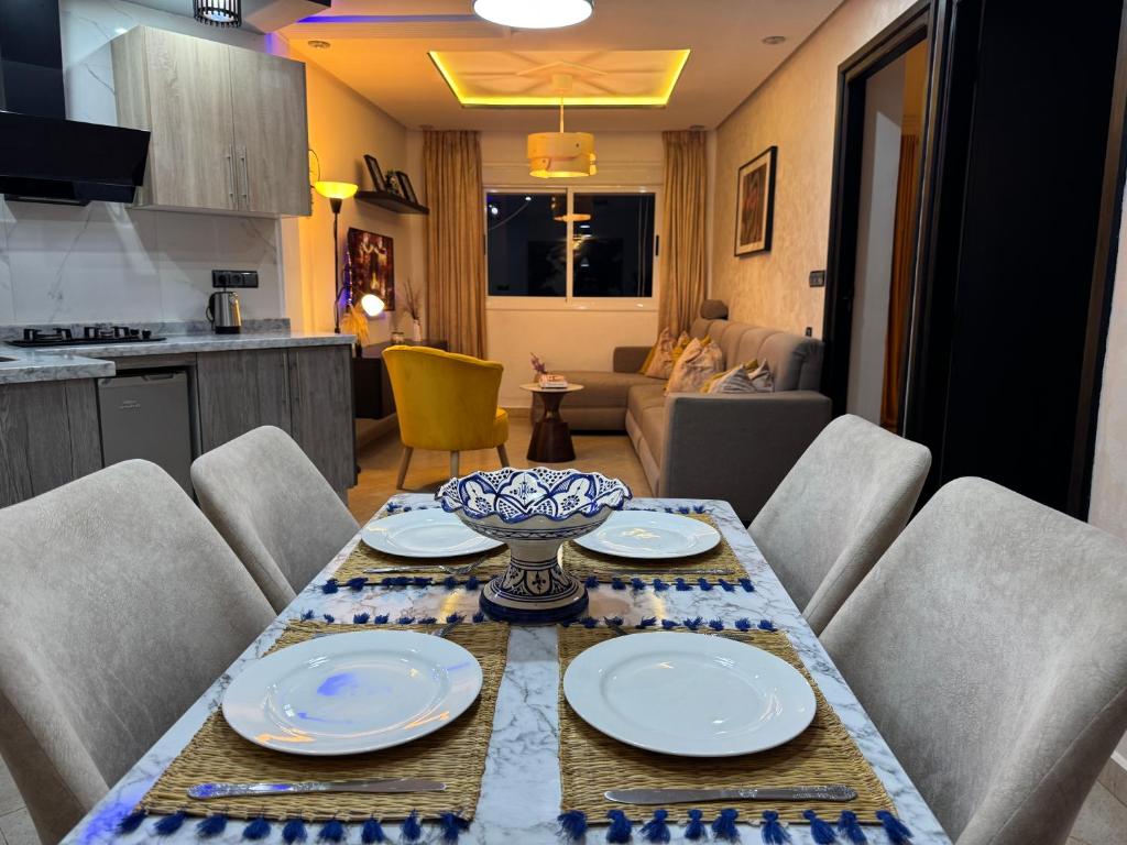 a table with plates and a bowl on top of it at Ramo house Central Comfort with Views in Chefchaouen