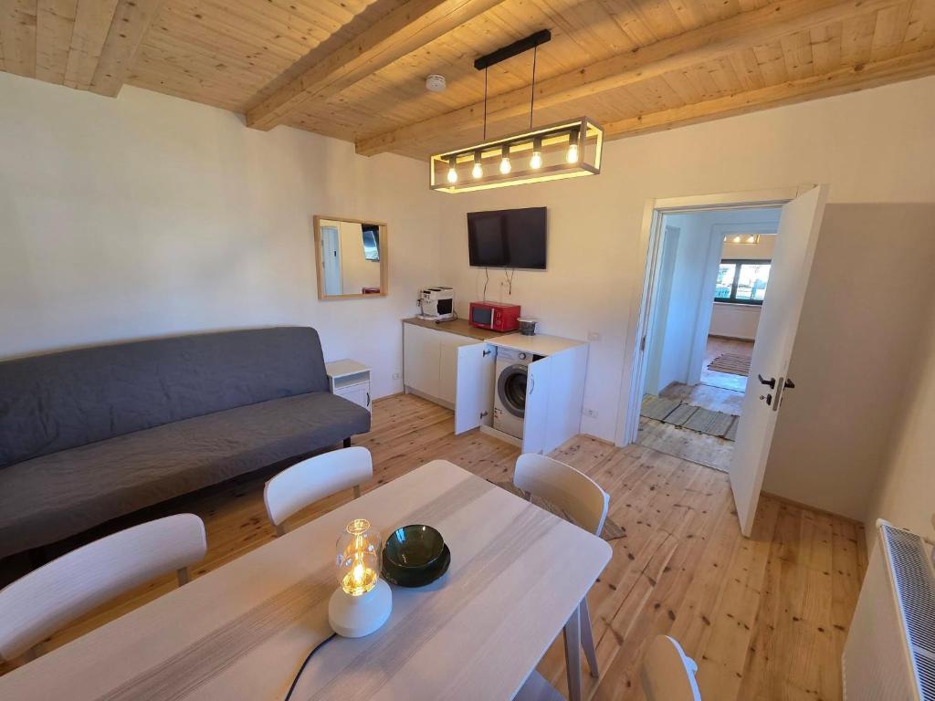 a living room with a couch and a table at La casa morarului in Cârțișoara