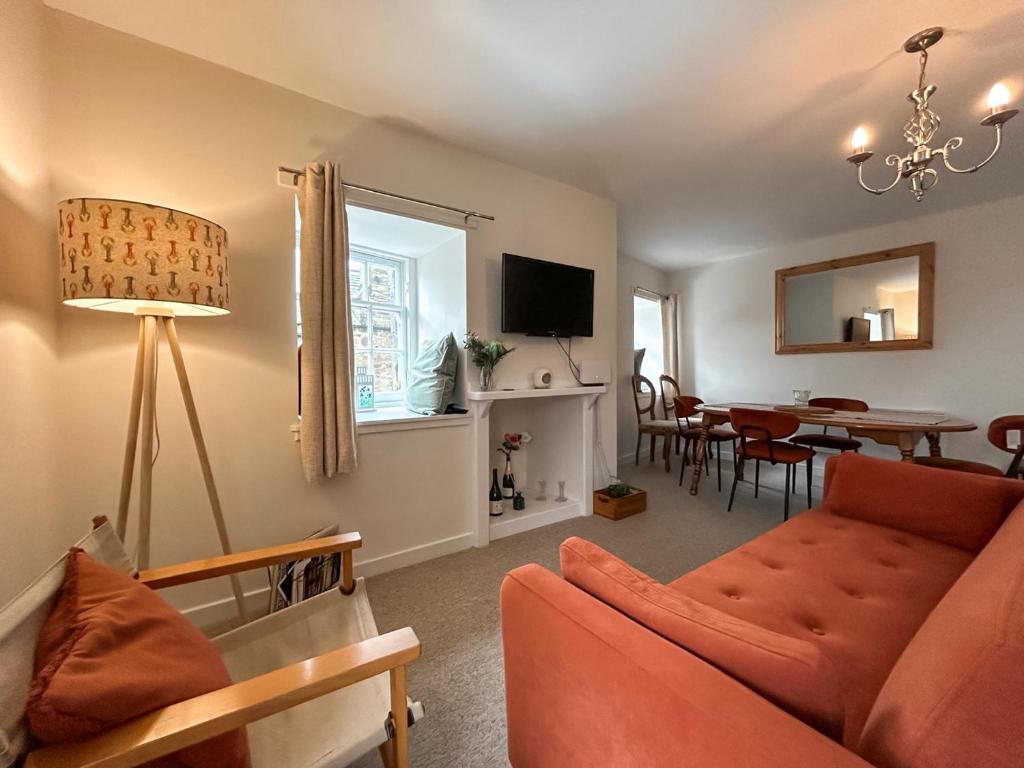 a living room with a couch and a dining room at Sea View Apartment in Anstruther