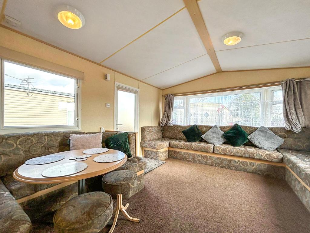 a living room with a couch and a table at Wah Caravan in Dundee
