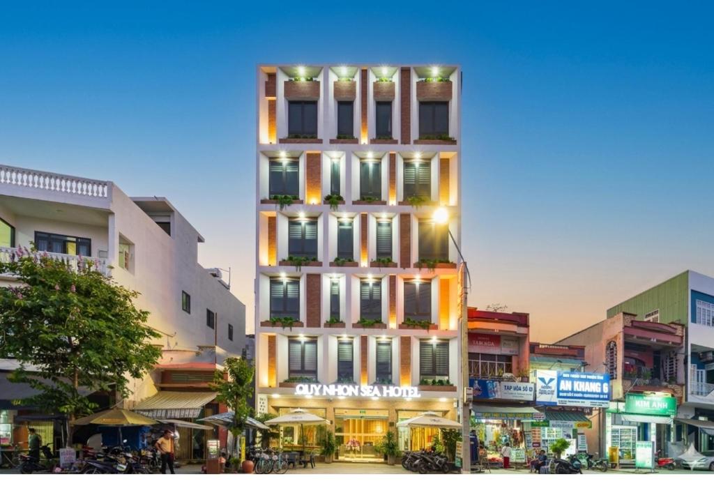 a tall building with a sign on the side of it at Quy Nhon Sea Hotel in Quy Nhon