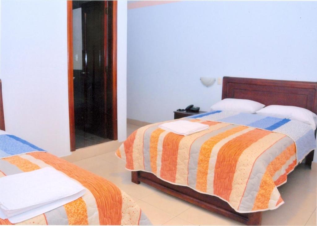 Postel nebo postele na pokoji v ubytování Hotel Caluva