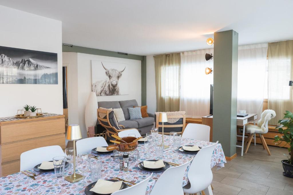 a living room with a table and a couch at Le Fleuron - Cosy and well centered - 6 ppl in Nendaz