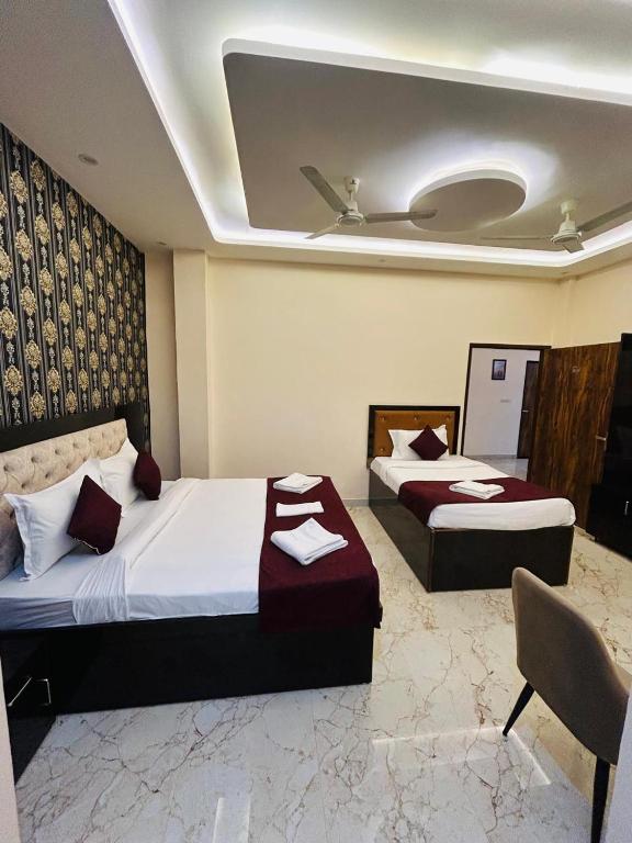 a bedroom with two beds and a ceiling at Hotel DVL INN- Near Jalmahal Jaipur in Jaipur