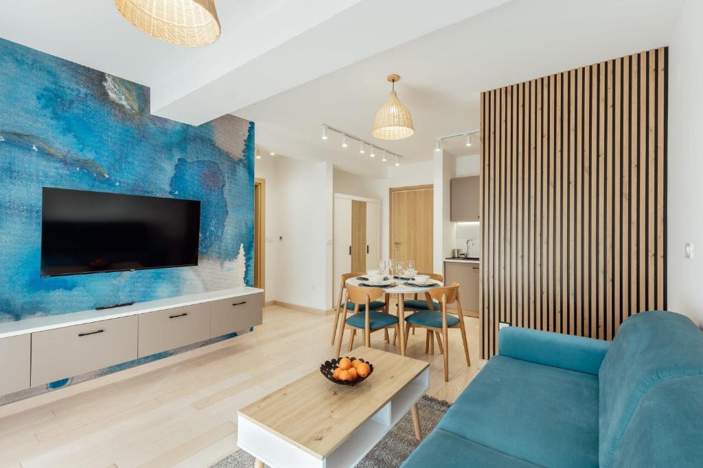a living room with a blue accent wall at Azure Bay in Igalo