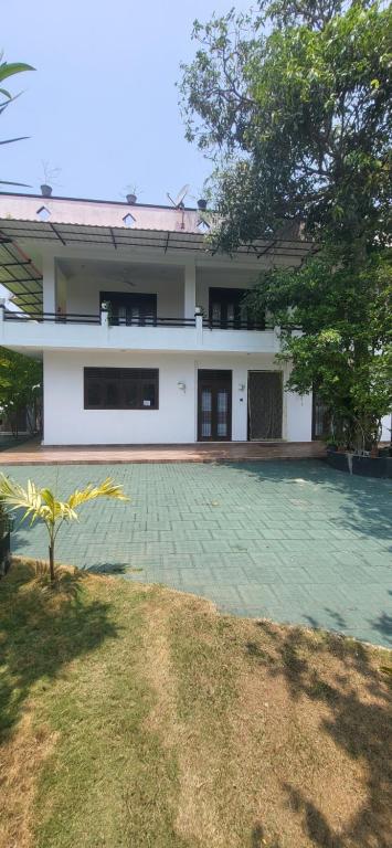 a house with a swimming pool in front of it at Villa Olive in Hikkaduwa