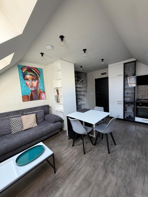 a living room with a couch and a table at Luxury flat 2 in Pleven