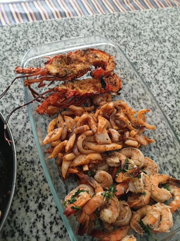 a glass container filled with shrimp on a table at Wasini dolphin adventure in Shimoni